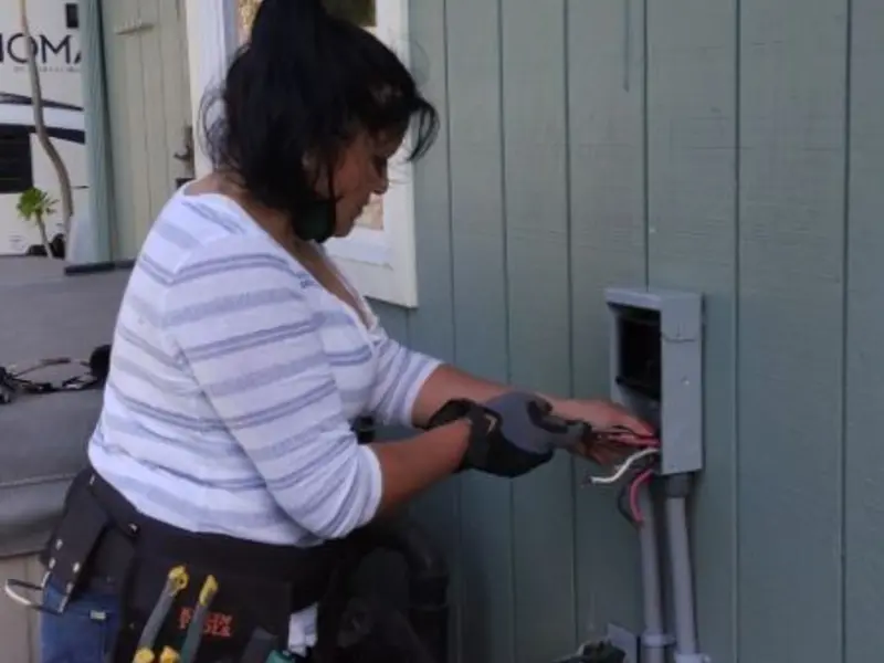 Licensed electrician wiring an exterior subpanel in Northglenn